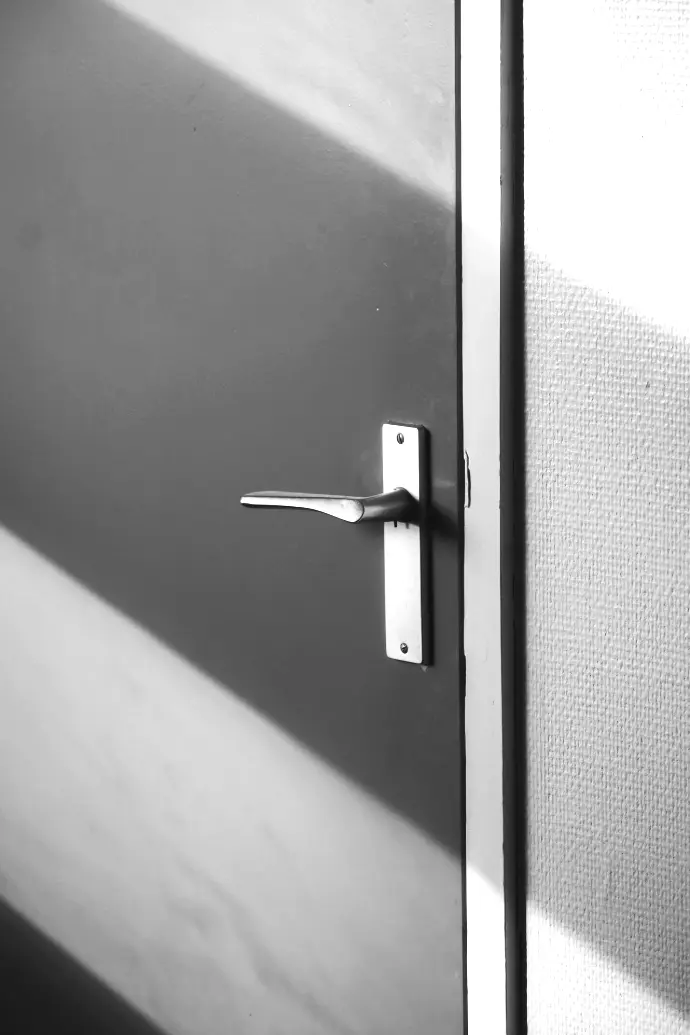 silver door lever on gray door